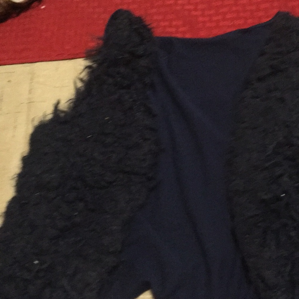 A navy blue vest fluffy on out side same color